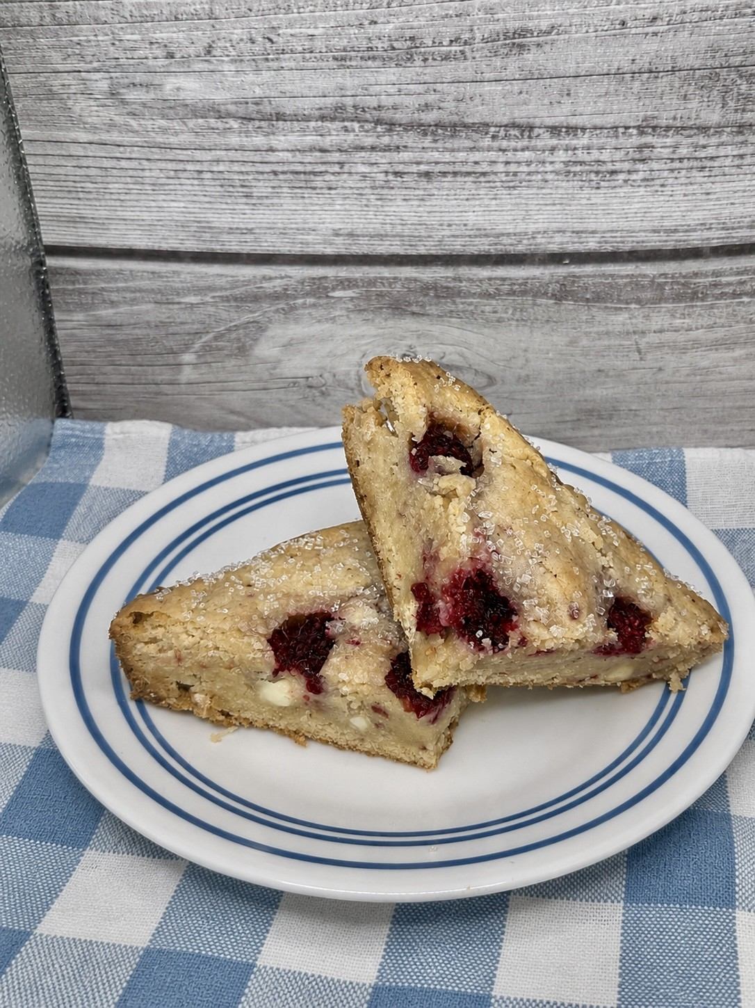 White chocolate raspberry blondies cut into triangles on a plate